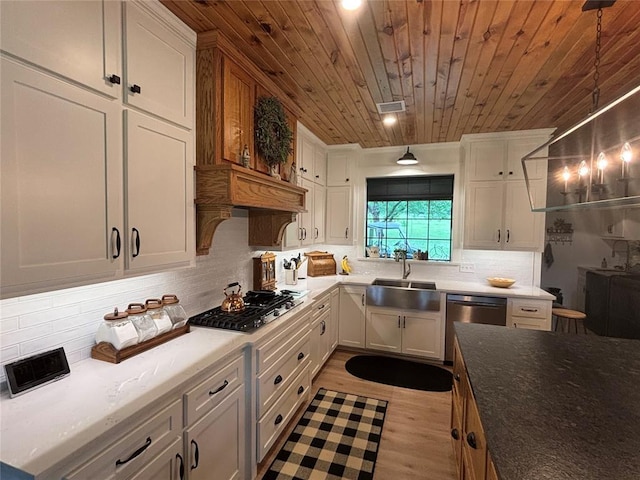 11790 E Etowah Rd, Noble, OK 73068 - kitchen featuring stainless steel appliances, wood ceiling, a sink, backsplash, and white cabinets