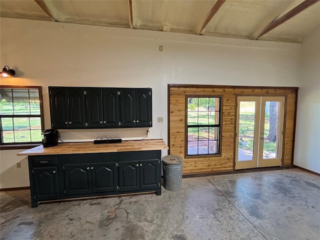 11790 E Etowah Rd, Noble, OK 73068 - kitchen with butcher block countertops, concrete flooring, french doors, dark cabinetry, and baseboards