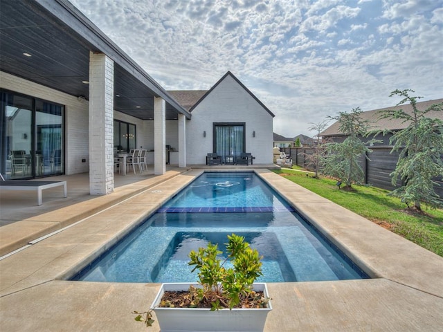 15929 Aparados Way, Edmond, OK 73013 - view of pool featuring a fenced backyard, a patio, a pool with connected hot tub, and outdoor dining area