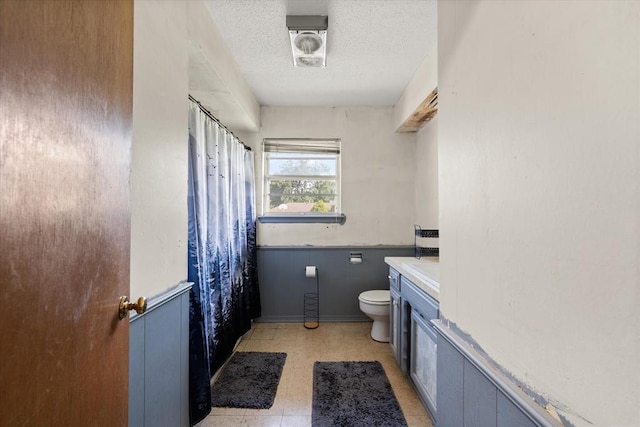 5712 NW 34th St, Oklahoma City, OK 73122 - bathroom featuring toilet, a textured ceiling, tile patterned floors, vanity, and a shower with curtain