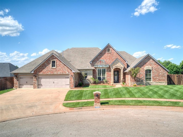 501 NW 154th St, Edmond, OK 73013 - view of front facade with brick siding, driveway, an attached garage, and a shingled roof
