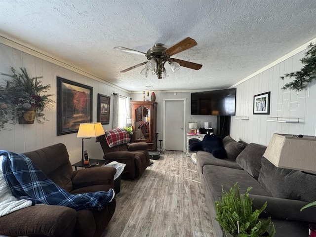 201 N Sheridan Ave, Dover, OK 73734 - living area featuring wood finished floors, crown molding, ceiling fan, a textured ceiling, and wood walls