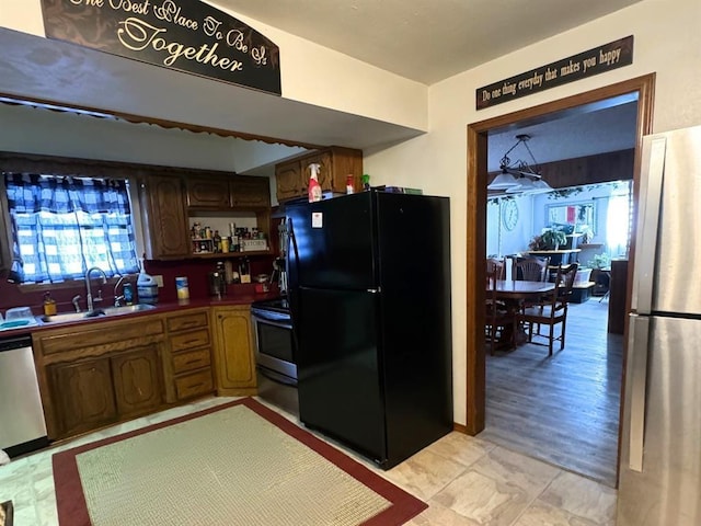 201 N Sheridan Ave, Dover, OK 73734 - kitchen with appliances with stainless steel finishes, a sink, and open shelves
