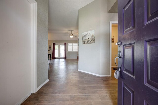 1001 Glacier Ln, Edmond, OK 73003 - foyer entrance featuring a ceiling fan, dark wood-style floors, baseboards, and a textured wall