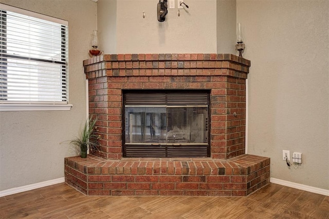 1001 Glacier Ln, Edmond, OK 73003 - detailed view of wood finished floors, baseboards, and a brick fireplace