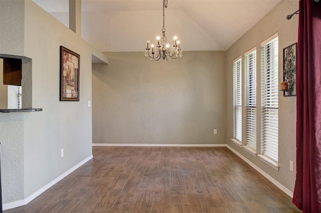 1001 Glacier Ln, Edmond, OK 73003 - empty room with lofted ceiling, healthy amount of natural light, a chandelier, and dark wood finished floors