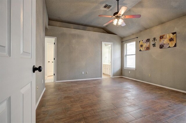 1001 Glacier Ln, Edmond, OK 73003 - spare room with vaulted ceiling, ceiling fan, wood finished floors, baseboards, and a textured wall
