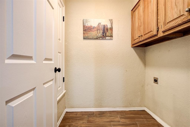 1001 Glacier Ln, Edmond, OK 73003 - laundry room featuring electric dryer hookup, cabinet space, baseboards, and dark wood-style flooring