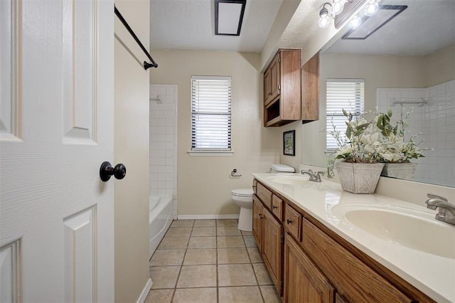 1001 Glacier Ln, Edmond, OK 73003 - full bath featuring plenty of natural light, double vanity, tile patterned floors, and toilet
