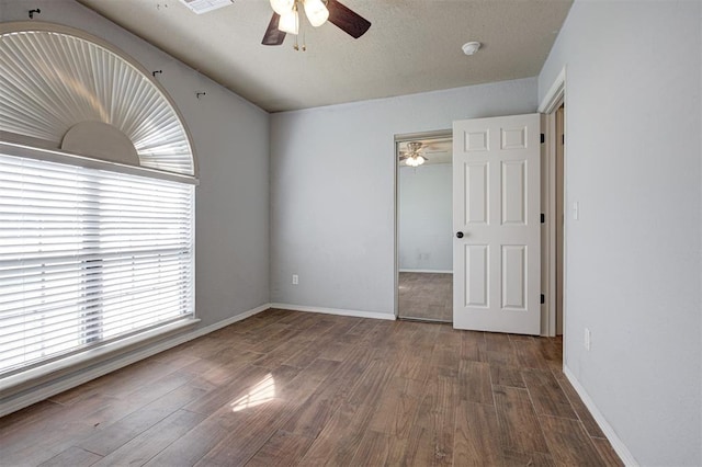 1001 Glacier Ln, Edmond, OK 73003 - unfurnished bedroom featuring wood finished floors, a closet, and baseboards