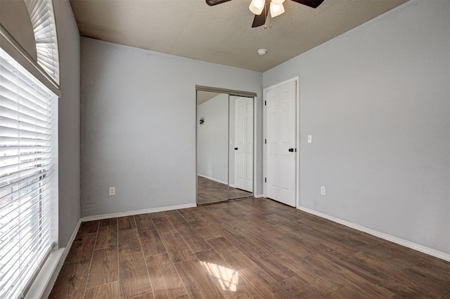 1001 Glacier Ln, Edmond, OK 73003 - unfurnished bedroom with wood finished floors, baseboards, a closet, and ceiling fan