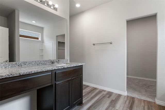 11325 SW 34th Ter, Yukon, OK 73099 - bathroom with vanity, wood finished floors, baseboards, and a walk in closet