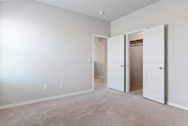 11325 SW 34th Ter, Yukon, OK 73099 - unfurnished bedroom featuring light carpet, baseboards, a spacious closet, and a closet