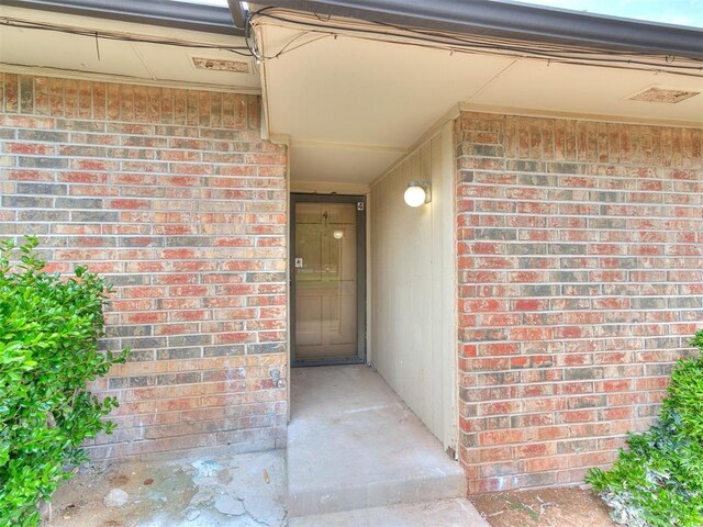 10125 N Pennsylvania Ave Unit 4, Oklahoma City, OK 73120 - doorway to property with brick siding