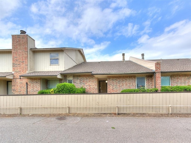 10125 N Pennsylvania Ave Unit 4, Oklahoma City, OK 73120 - view of front of house with brick siding and roof with shingles