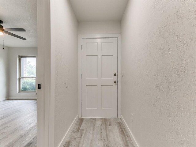 10125 N Pennsylvania Ave Unit 4, Oklahoma City, OK 73120 - entryway featuring light wood-style flooring, baseboards, a ceiling fan, and a textured wall