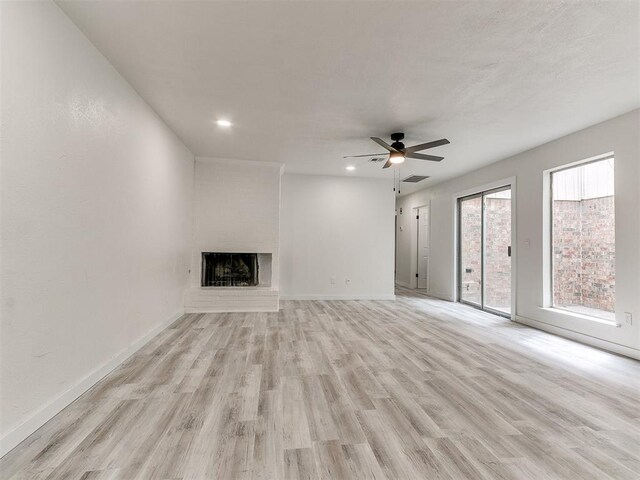 10125 N Pennsylvania Ave Unit 4, Oklahoma City, OK 73120 - unfurnished living room with light wood-style floors, ceiling fan, baseboards, a fireplace, and recessed lighting