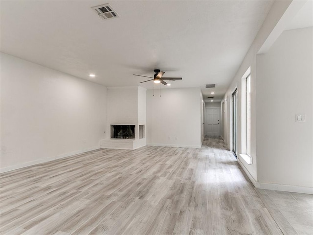10125 N Pennsylvania Ave Unit 4, Oklahoma City, OK 73120 - unfurnished living room with a ceiling fan, light wood-style flooring, baseboards, and a multi sided fireplace