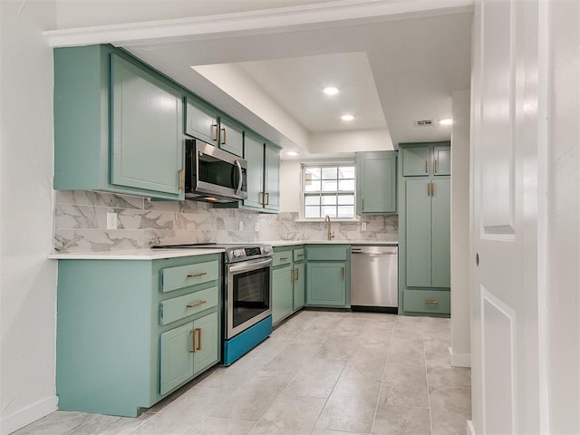 10125 N Pennsylvania Ave Unit 4, Oklahoma City, OK 73120 - kitchen with appliances with stainless steel finishes, green cabinets, decorative backsplash, light countertops, and recessed lighting