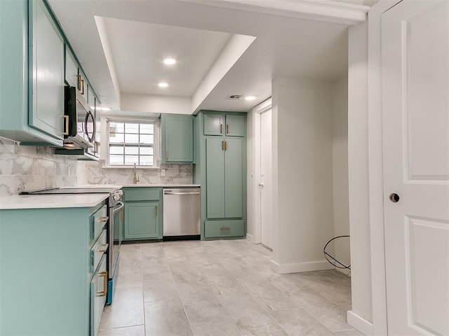 10125 N Pennsylvania Ave Unit 4, Oklahoma City, OK 73120 - kitchen with green cabinetry, stainless steel appliances, a sink, light countertops, and tasteful backsplash