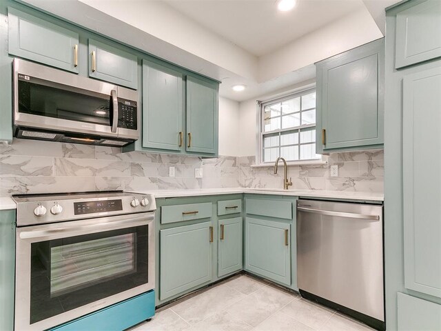 10125 N Pennsylvania Ave Unit 4, Oklahoma City, OK 73120 - kitchen featuring appliances with stainless steel finishes, green cabinets, light countertops, and recessed lighting