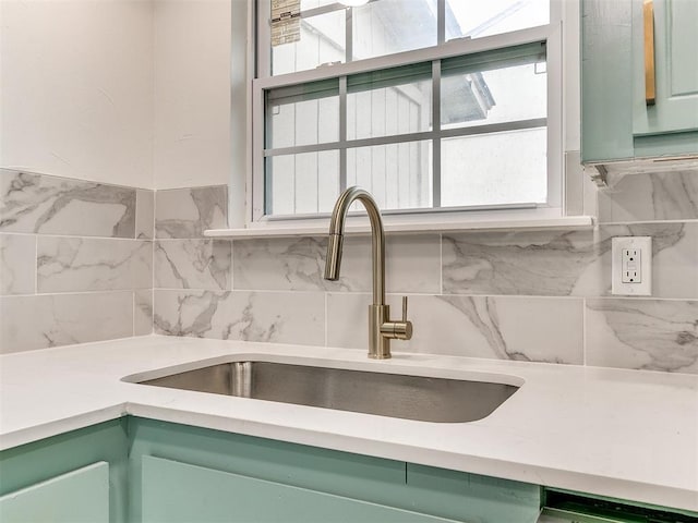 10125 N Pennsylvania Ave Unit 4, Oklahoma City, OK 73120 - kitchen view of green cabinetry, a sink, and tasteful backsplash