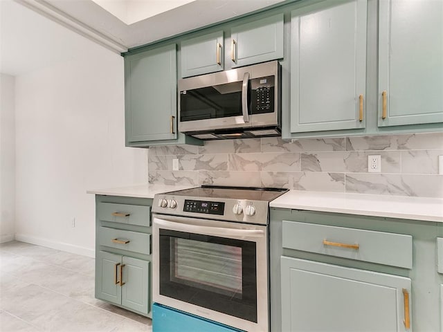 10125 N Pennsylvania Ave Unit 4, Oklahoma City, OK 73120 - kitchen featuring appliances with stainless steel finishes, green cabinets, baseboards, light countertops, and decorative backsplash