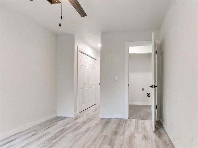 10125 N Pennsylvania Ave Unit 4, Oklahoma City, OK 73120 - unfurnished bedroom featuring a closet, light wood-type flooring, baseboards, and a ceiling fan
