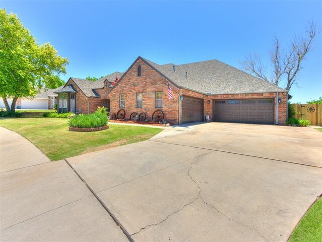 19609 Filly Dr, Edmond, OK 73003 - view of front of property featuring a garage, brick siding, and concrete driveway