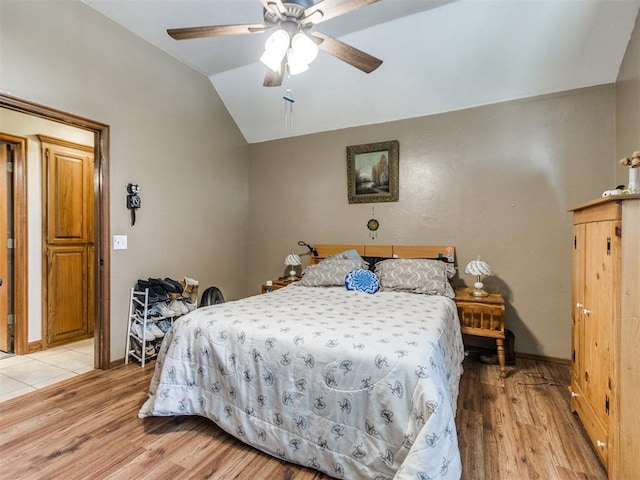 19609 Filly Dr, Edmond, OK 73003 - bedroom with lofted ceiling, light wood finished floors, baseboards, and ceiling fan