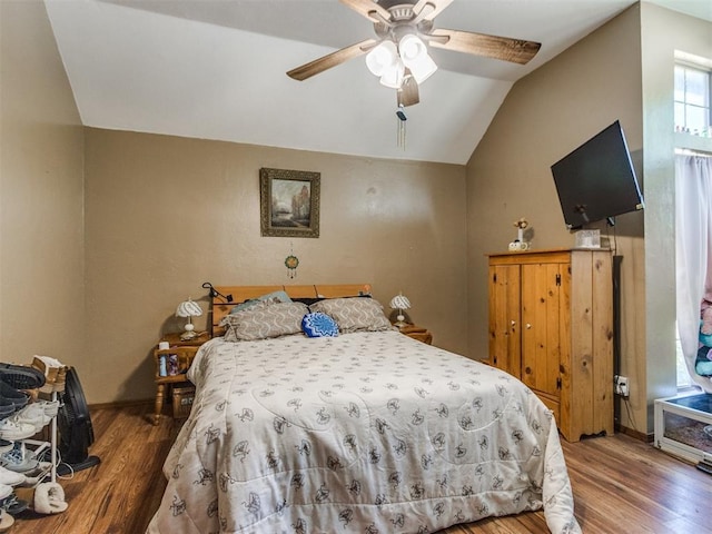 19609 Filly Dr, Edmond, OK 73003 - bedroom featuring wood finished floors, vaulted ceiling, baseboards, and ceiling fan