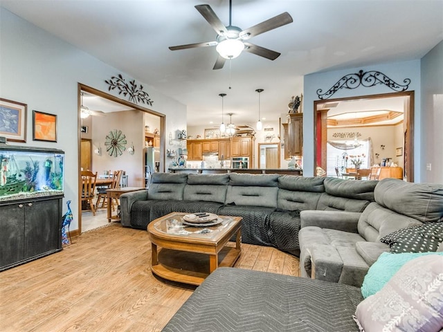 19609 Filly Dr, Edmond, OK 73003 - living area featuring a ceiling fan, light wood finished floors, and a chandelier