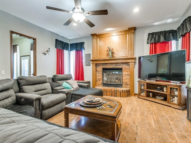 19609 Filly Dr, Edmond, OK 73003 - living area featuring a fireplace, ceiling fan, wood finished floors, and recessed lighting