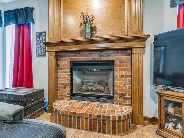 19609 Filly Dr, Edmond, OK 73003 - detailed view of wood finished floors, a fireplace, and baseboards