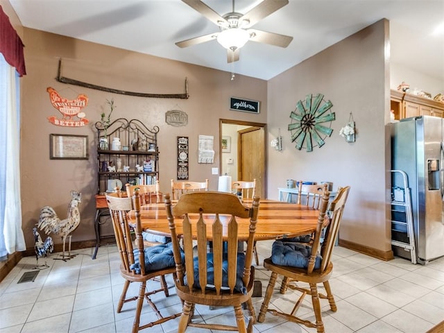 19609 Filly Dr, Edmond, OK 73003 - dining space featuring light tile patterned floors, a ceiling fan, and baseboards