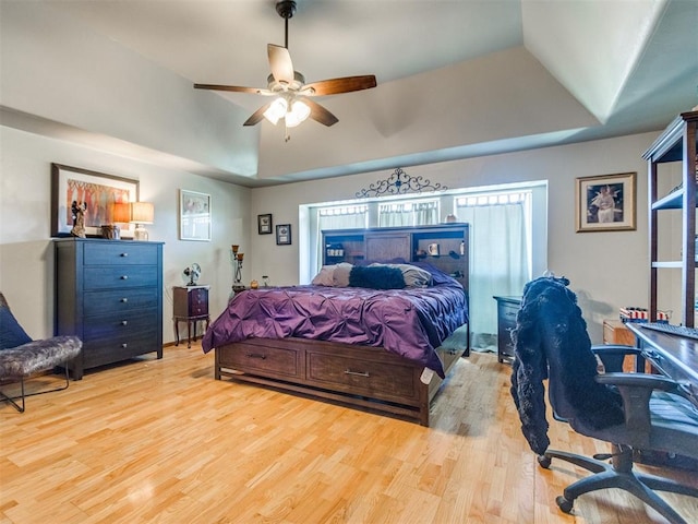 19609 Filly Dr, Edmond, OK 73003 - bedroom with wood finished floors, a raised ceiling, and a ceiling fan