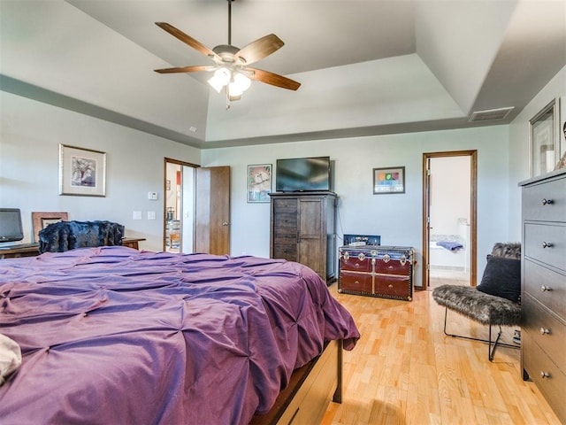 19609 Filly Dr, Edmond, OK 73003 - bedroom featuring a raised ceiling and light wood finished floors