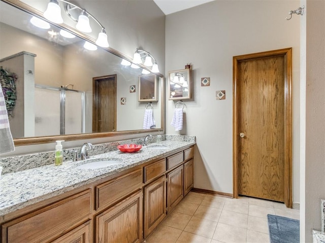 19609 Filly Dr, Edmond, OK 73003 - bathroom with double vanity, tile patterned flooring, and a shower with door