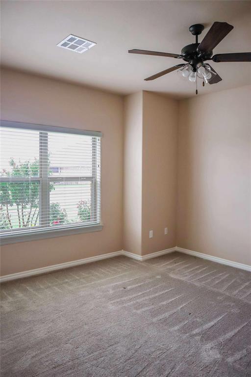 1417 Dustbowl Ln, Altus, OK 73521 - empty room featuring carpet flooring, baseboards, and a ceiling fan