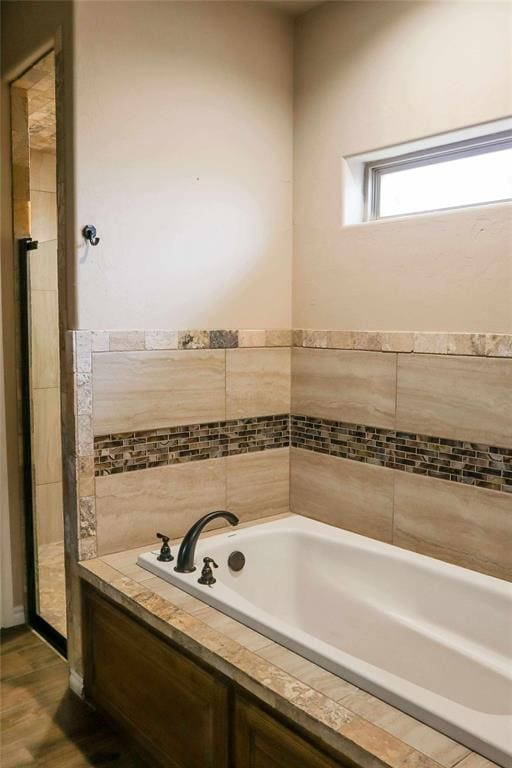 1417 Dustbowl Ln, Altus, OK 73521 - bathroom with a garden tub and wood finished floors