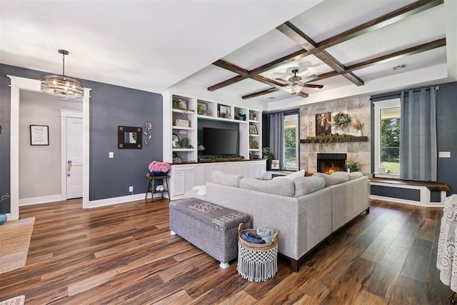 4706 Red Hawk St, Guthrie, OK 73044 - living area featuring coffered ceiling, dark wood-style floors, baseboards, ceiling fan, and a large fireplace