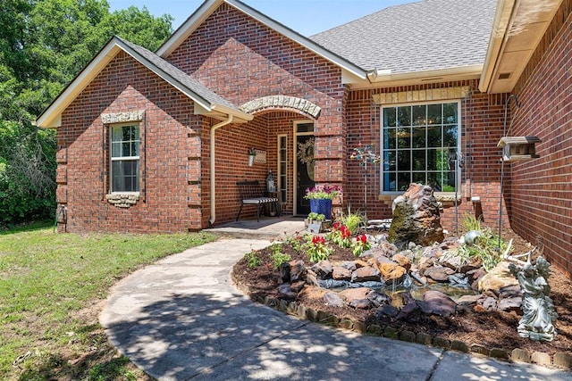 4706 Red Hawk St, Guthrie, OK 73044 - view of front facade featuring brick siding, roof with shingles, a patio area, and a front yard