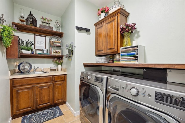 4706 Red Hawk St, Guthrie, OK 73044 - laundry area with separate washer and dryer, cabinet space, light tile patterned floors, and baseboards