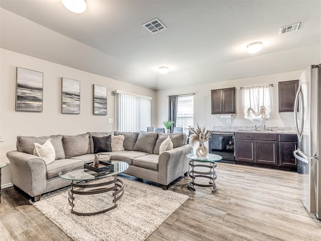 11621 Jude Way, Yukon, OK 73099 - living area featuring light wood-type flooring and lofted ceiling