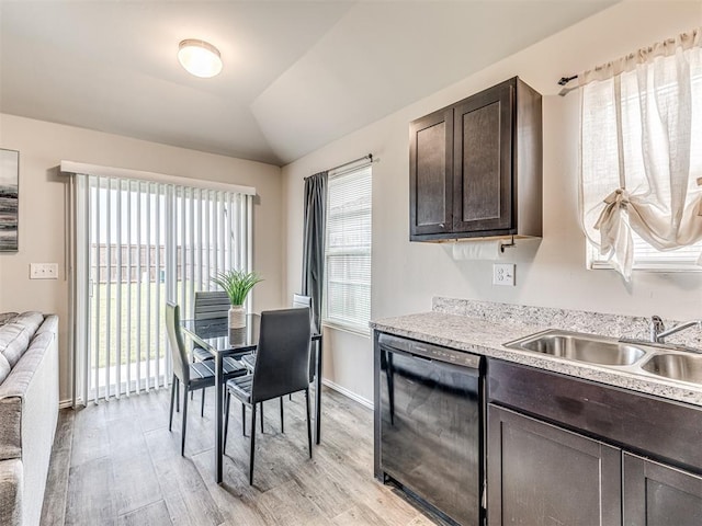 11621 Jude Way, Yukon, OK 73099 - kitchen with black dishwasher, dark brown cabinets, a sink, light wood-style flooring, and light countertops