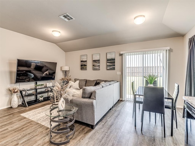 11621 Jude Way, Yukon, OK 73099 - living room with vaulted ceiling, wood finished floors, and baseboards