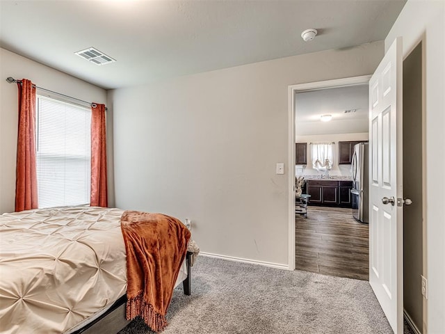 11621 Jude Way, Yukon, OK 73099 - bedroom featuring freestanding refrigerator, dark colored carpet, and baseboards