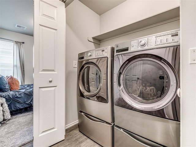 11621 Jude Way, Yukon, OK 73099 - laundry room featuring independent washer and dryer, wood finished floors, and baseboards