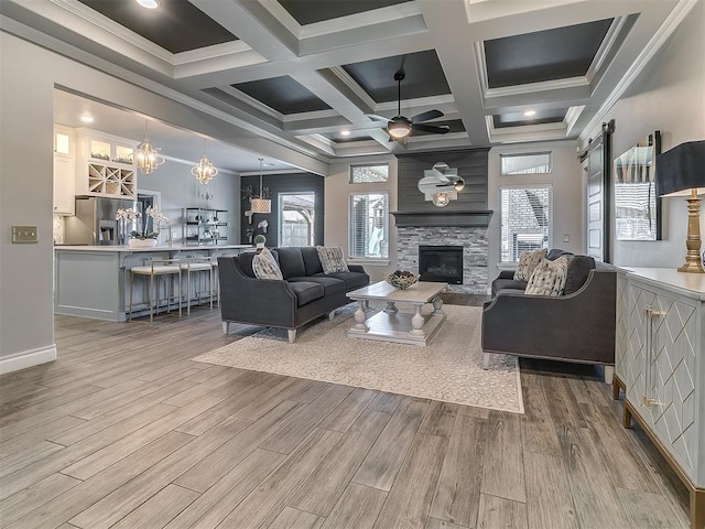 12801 Red Spruce Cir, Oklahoma City, OK 73142 - living area with ceiling fan, wood finished floors, a fireplace, healthy amount of natural light, and coffered ceiling