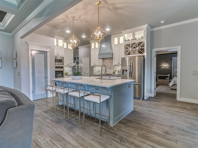 12801 Red Spruce Cir, Oklahoma City, OK 73142 - kitchen featuring stainless steel appliances, a chandelier, ornamental molding, backsplash, and premium range hood